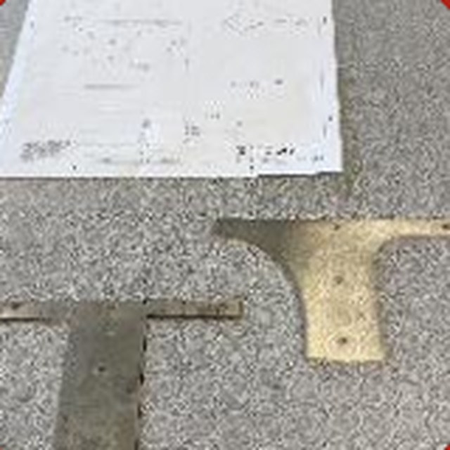 A metal bracket laid on a printed drawing